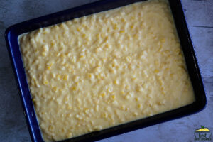 Creamed corn casserole spread in baking dish