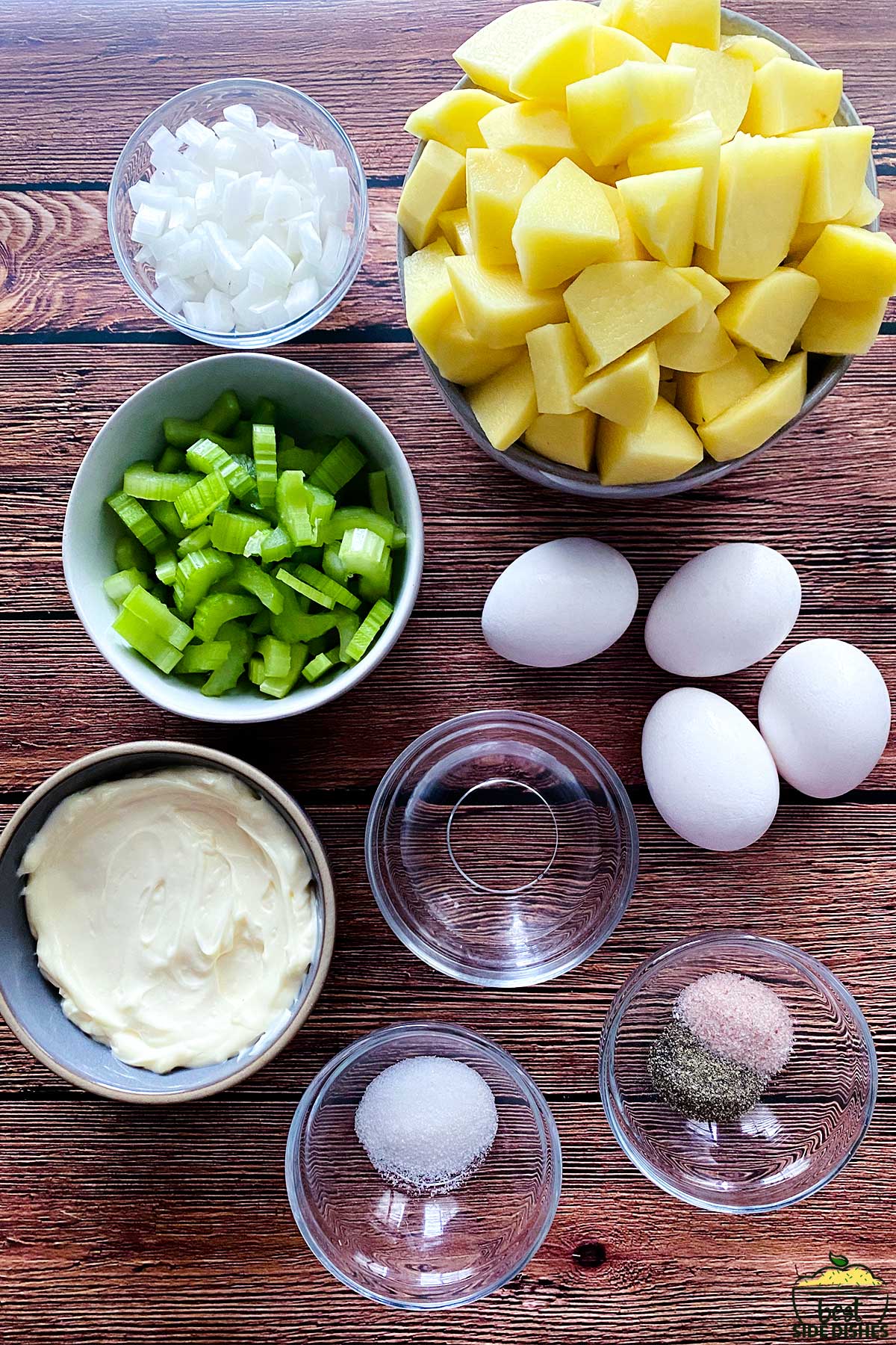 potato salad ingredients on a table in bowls