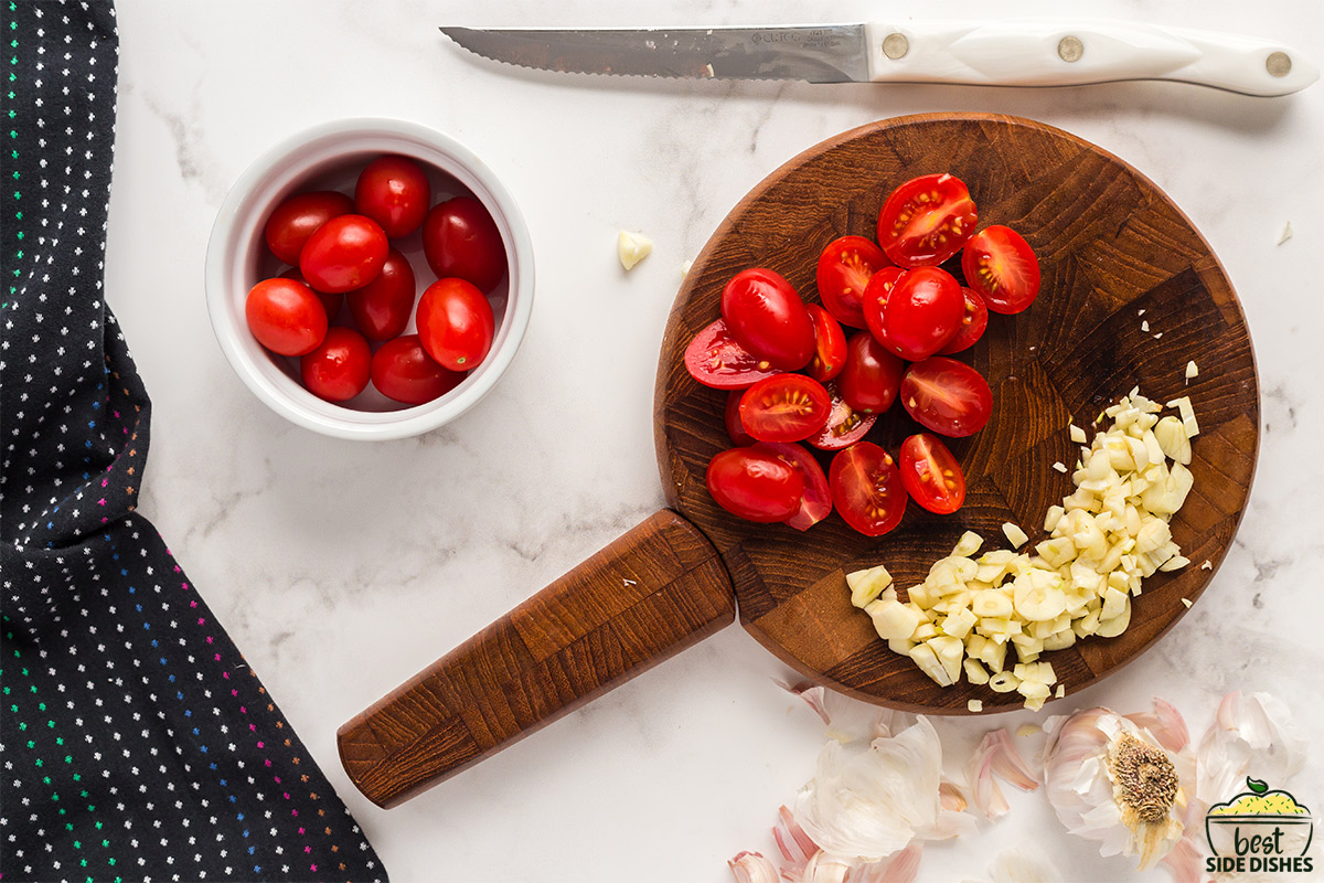 Chopped garlic and tomatoes on a wooden board