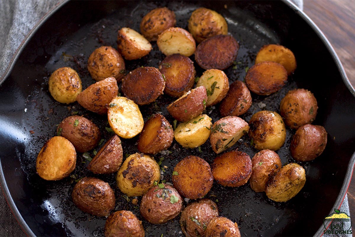 crispy roasted garlic potatoes in a cast iron pan