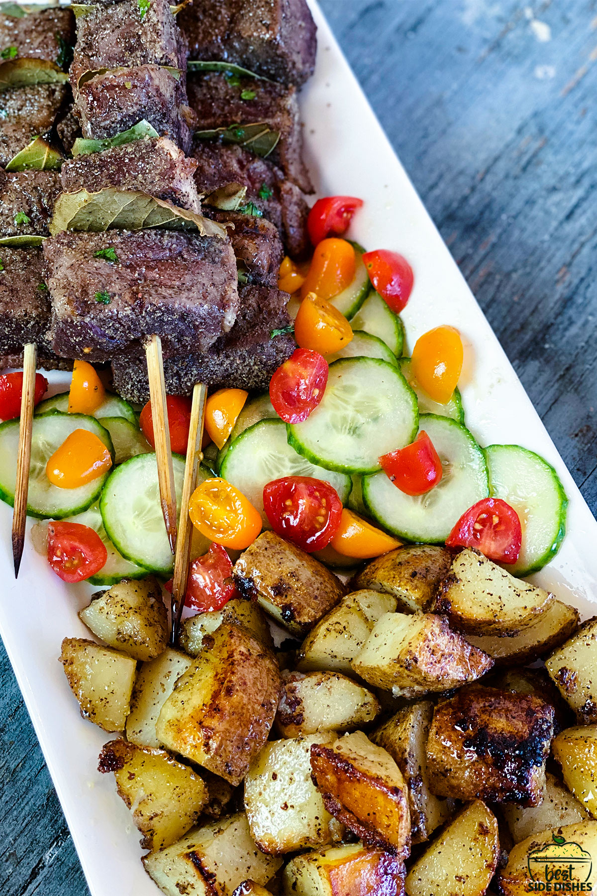 platter with beef, vegetables, and crispy grilled potatoes