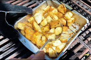 Potatoes on the grill in a baking dish