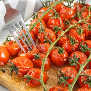 Roasted tomatoes up close with a fork