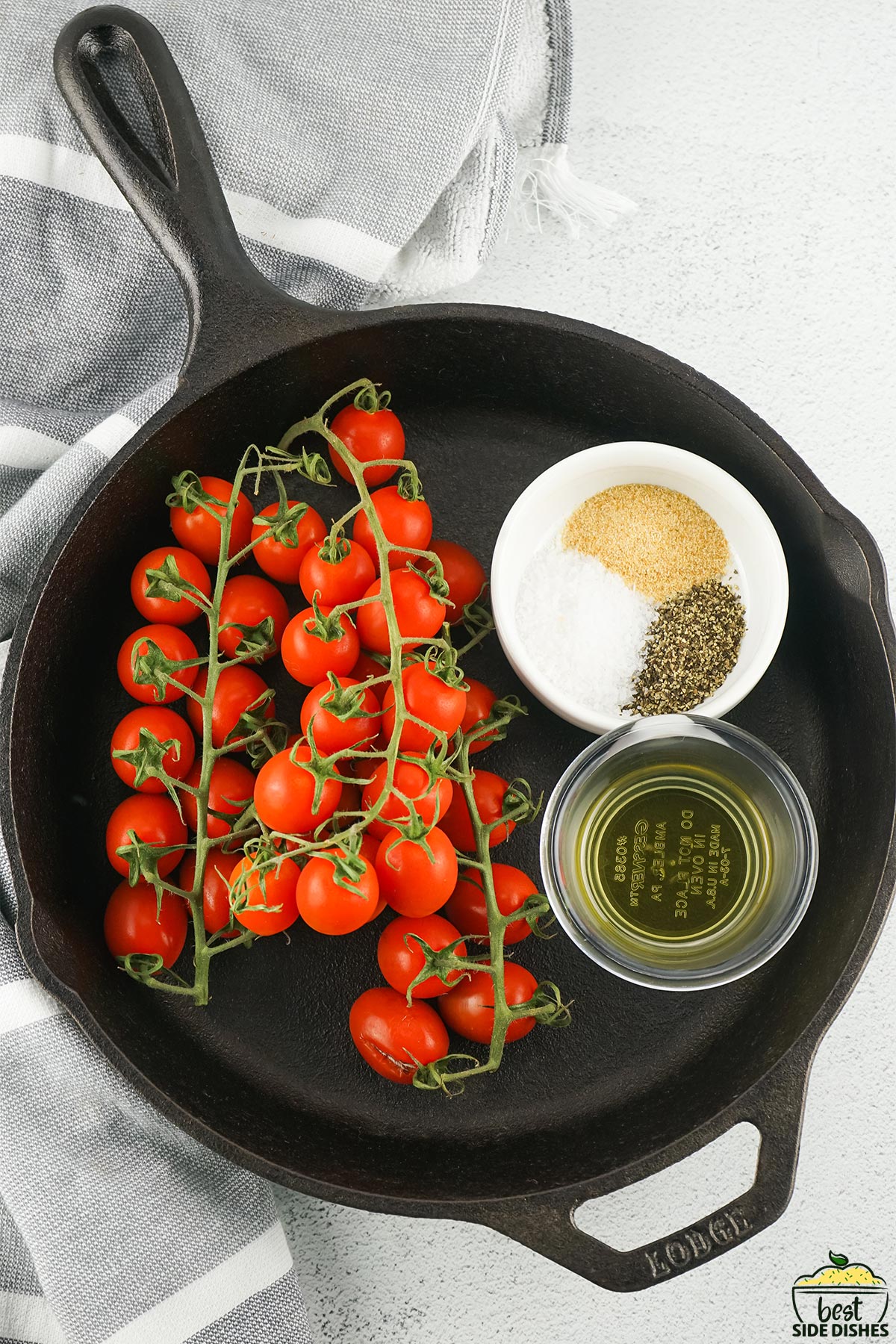 Grape tomatoes, salt, pepper, garlic powder, and olive oil in bowls in a skillet