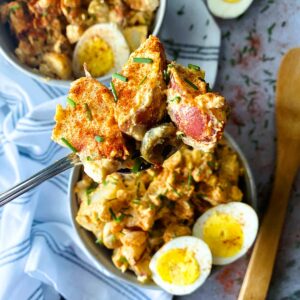 spanish potato salad in a bowl with eggs