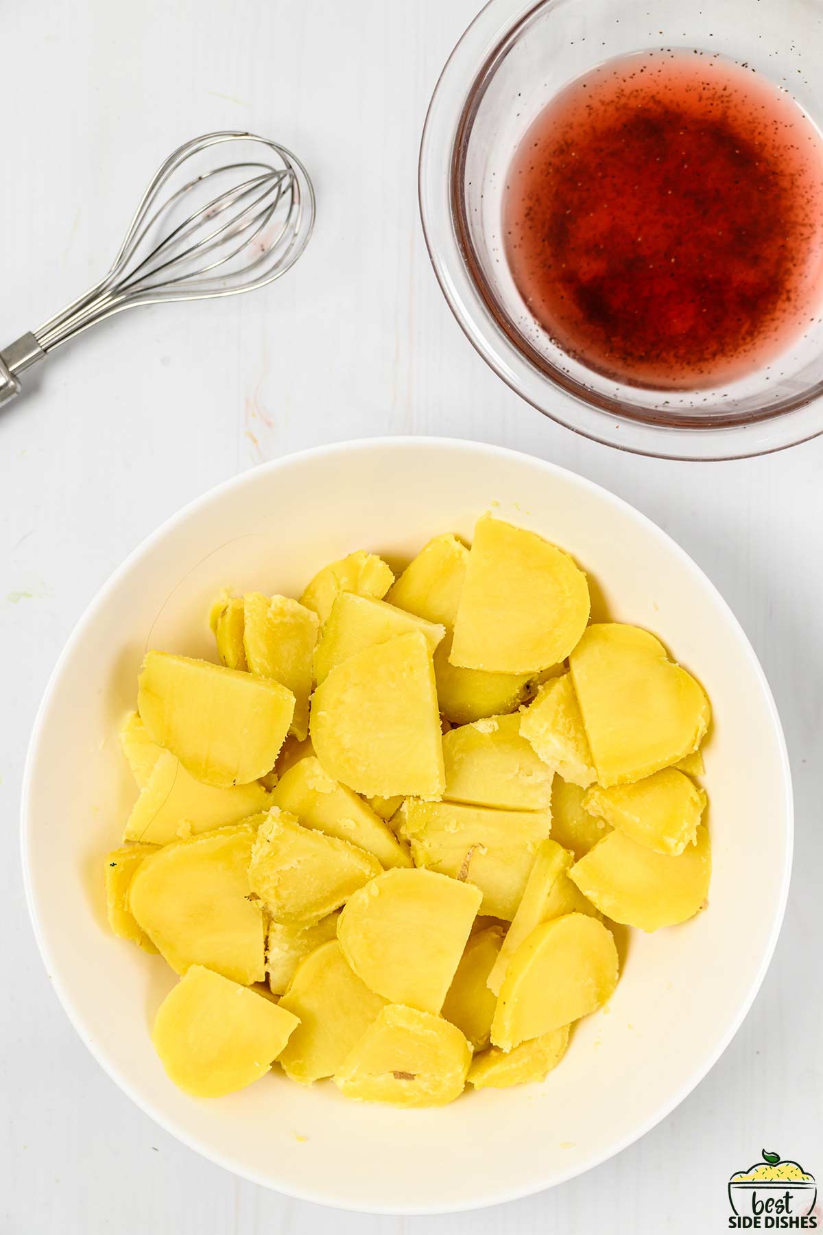 mixing potatoes with vinegars in a bowl