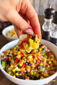 Dipping a chip in black eyed pea salad