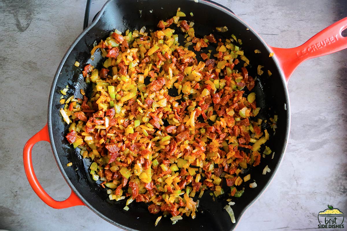 cooking chorizo with vegetables in a pan