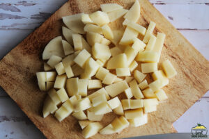 potatoes diced on a wood cutting board