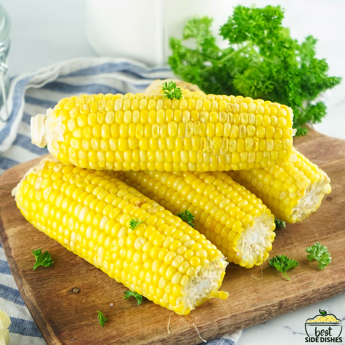 four instant pot corn on the cob on a wooden board
