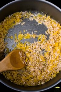 browning noodles and rice in a pan
