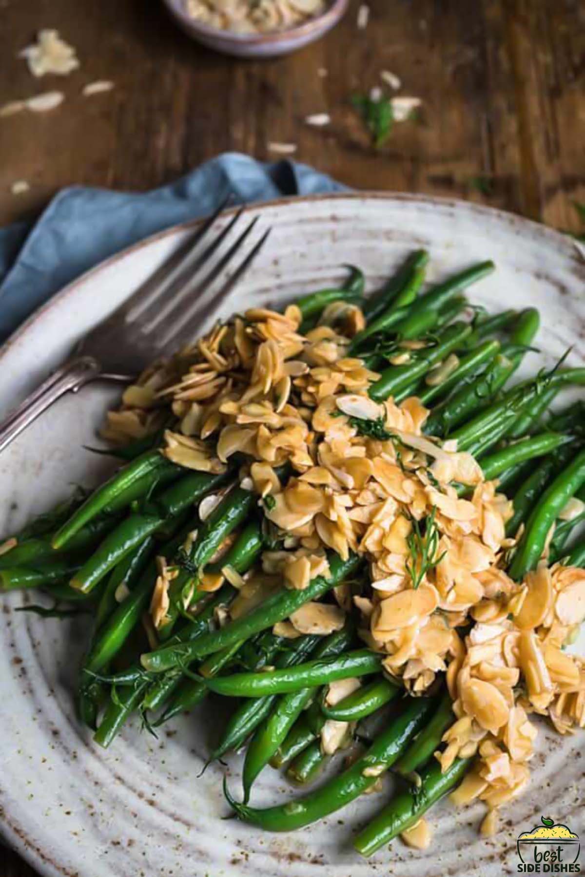 green bean amandine on a plate with a fork