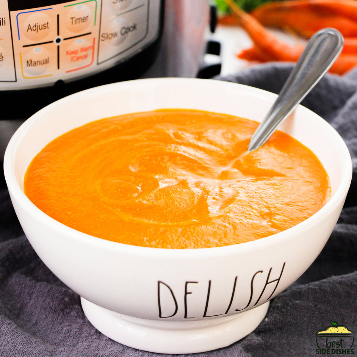 a bowl of instant pot carrot soup with an instant pot in the background