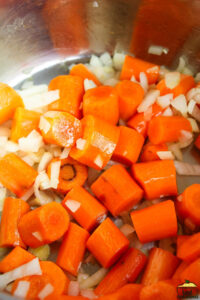 sauteed carrots in an instant pot with onions, garlic and ginger added