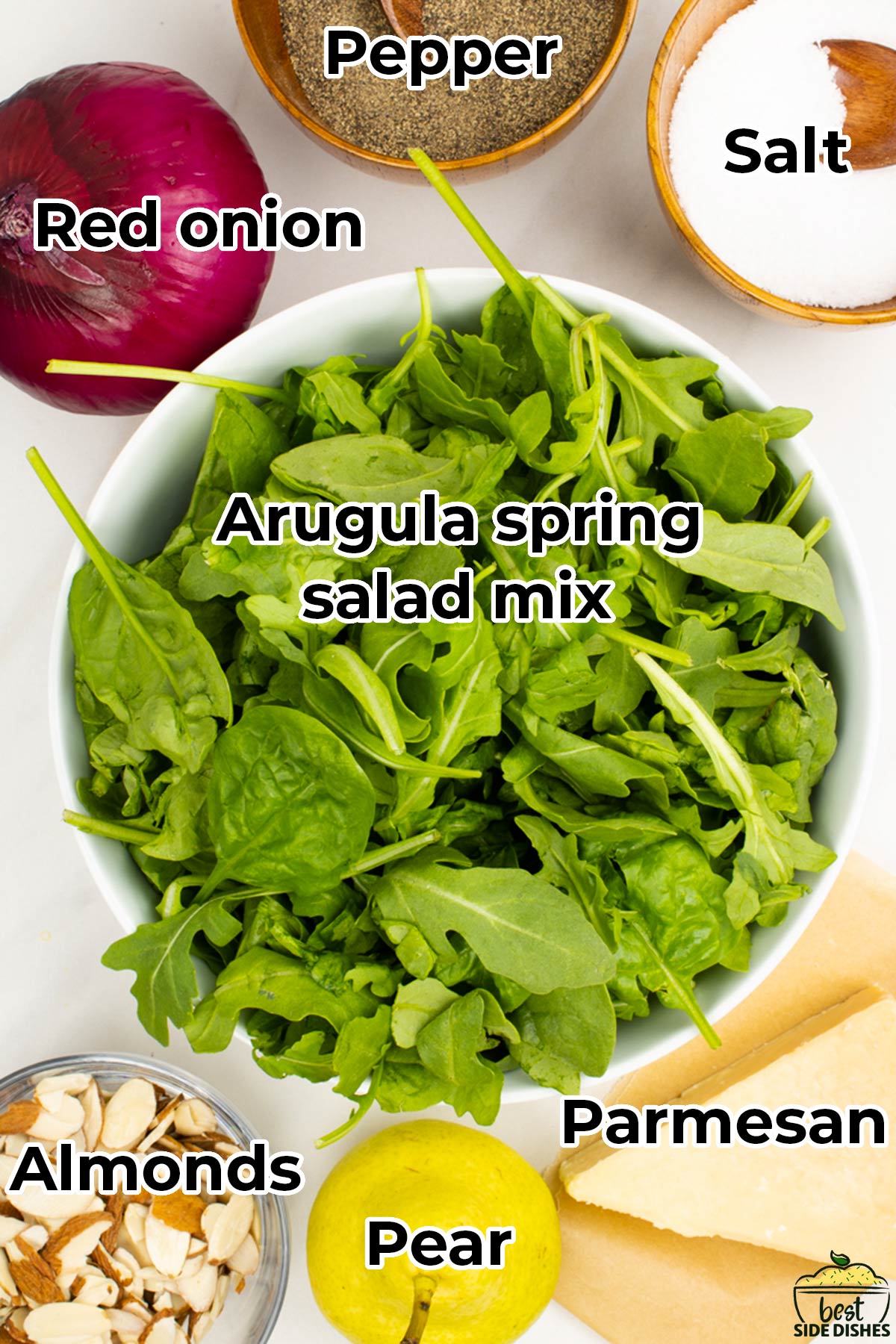 the ingredients for salad in separate bowls with labels