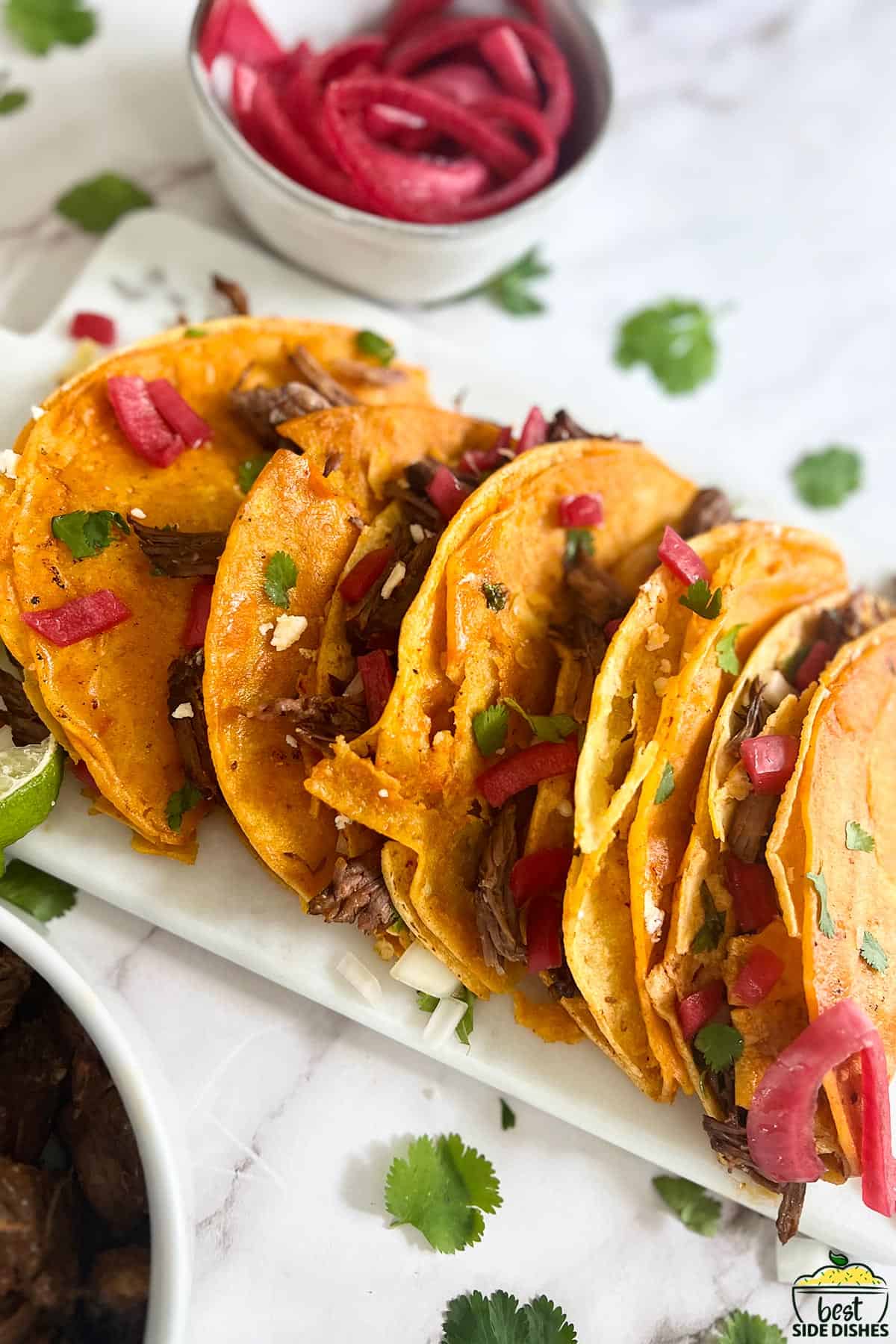 red pickled onions over tacos