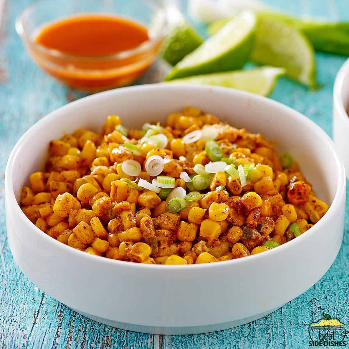 a white bowl filled with completed Mexican corn casserole
