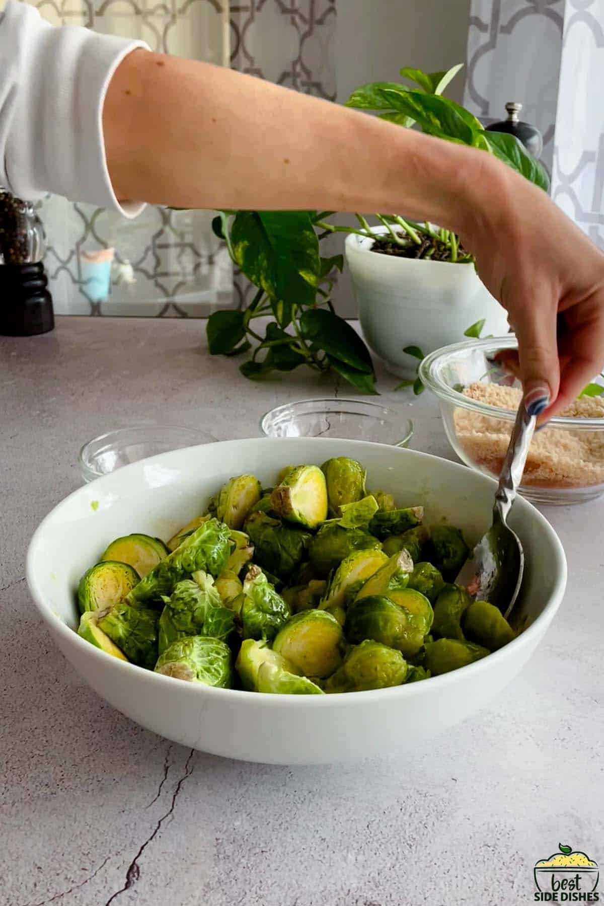 mixing brussels sprouts in a bowl