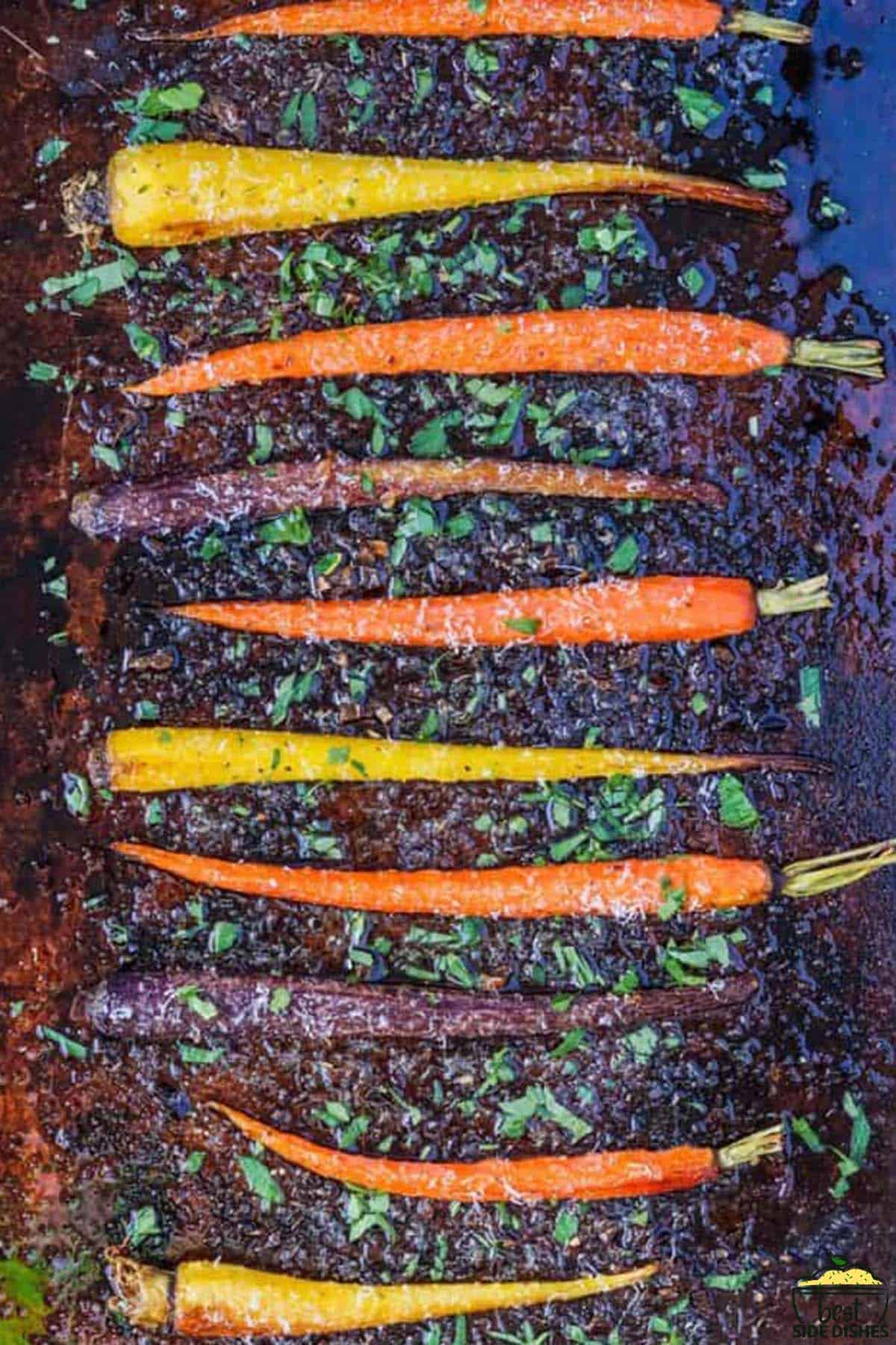 colorful roast carrots on a baking sheet