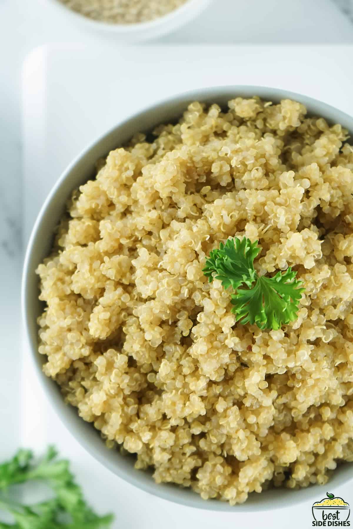 a top down view of tender quinoa in a white bowl