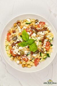 a bowl of mediterranean couscous salad after mixing