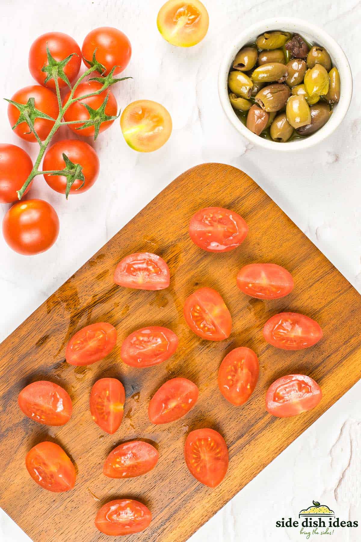 tomatoes halved on a cutting board