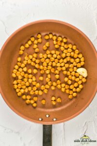 chickpeas and garlic in a skillet