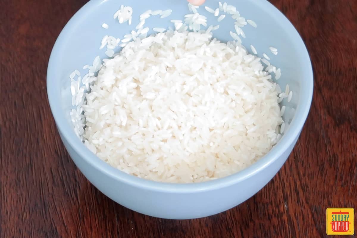 washed rice in a blue bowl