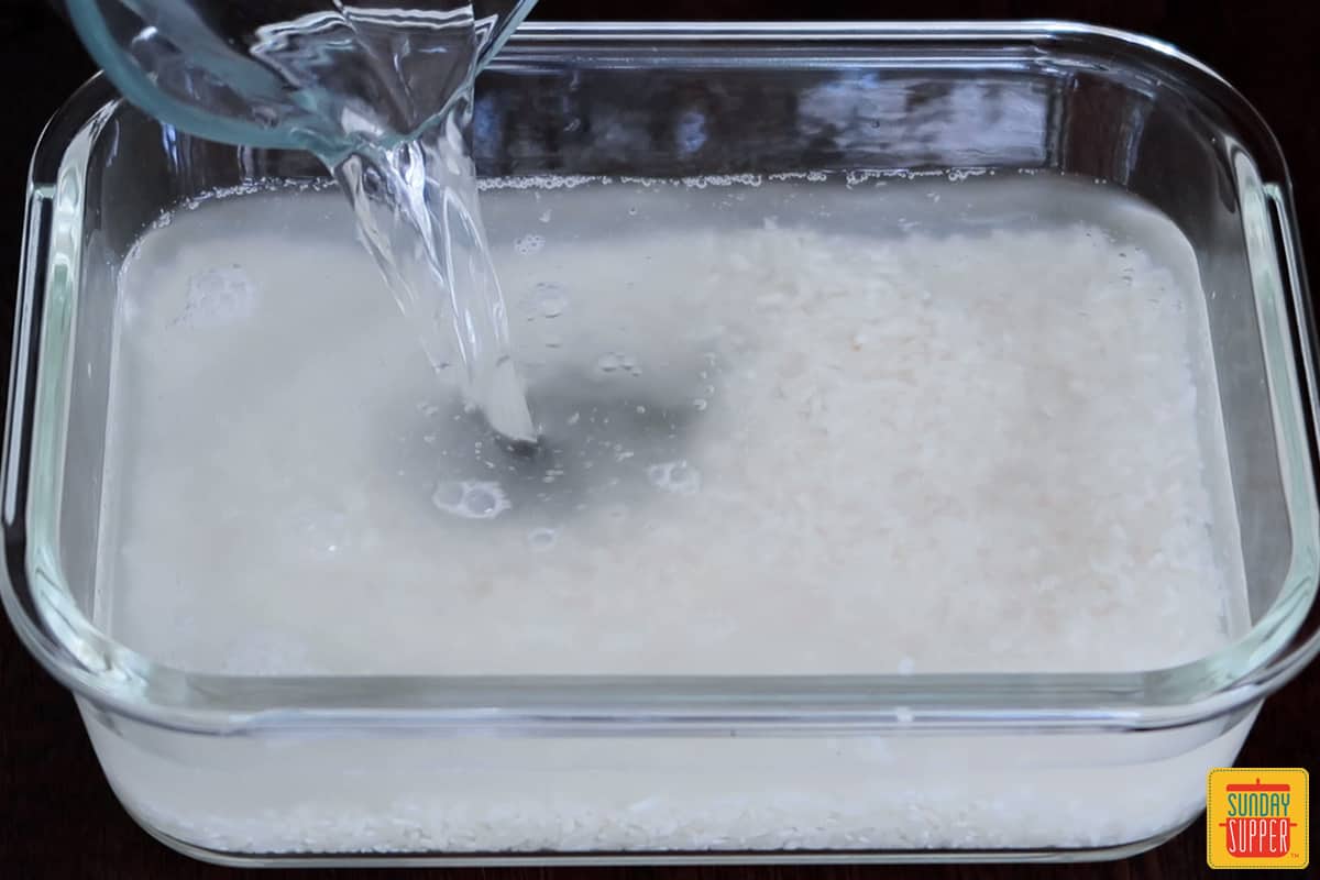 rice and water in a microwave safe container
