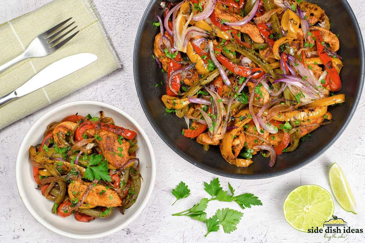 serving fajita vegetables with chicken and cilantro in a bowl next to the pan