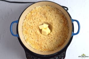 adding butter to pot of rice