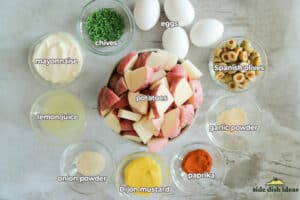 ingredients to make mustard potato salad in bowls with labels