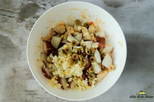 potato salad ingredients added to bowl