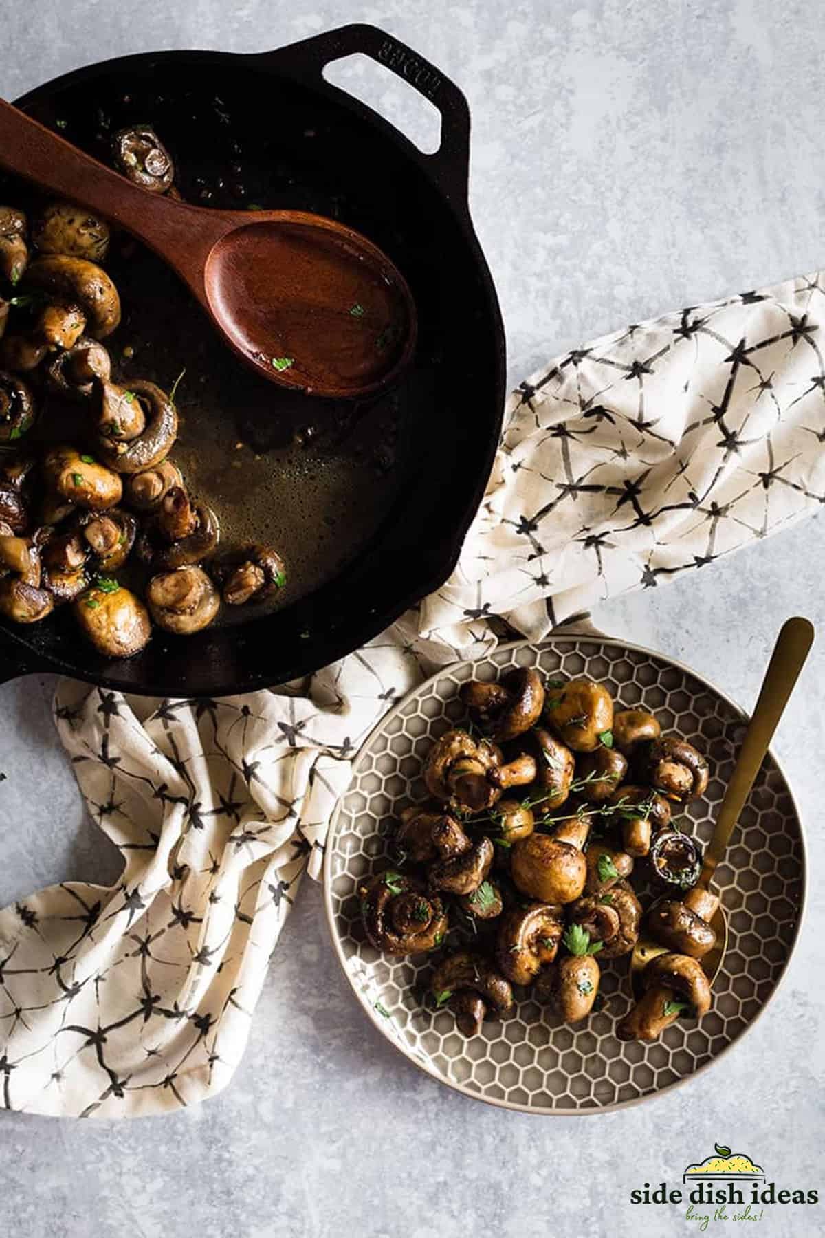 white button mushrooms in a pan next to a plate of mushrooms with herbs