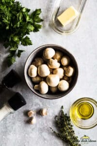 ingredients to make white button mushrooms on a table
