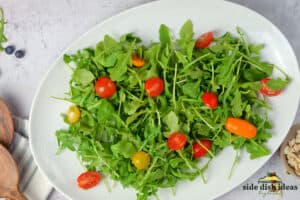 topping arugula with cherry tomatoes