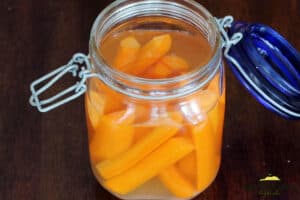 adding ingredients to pickle carrots