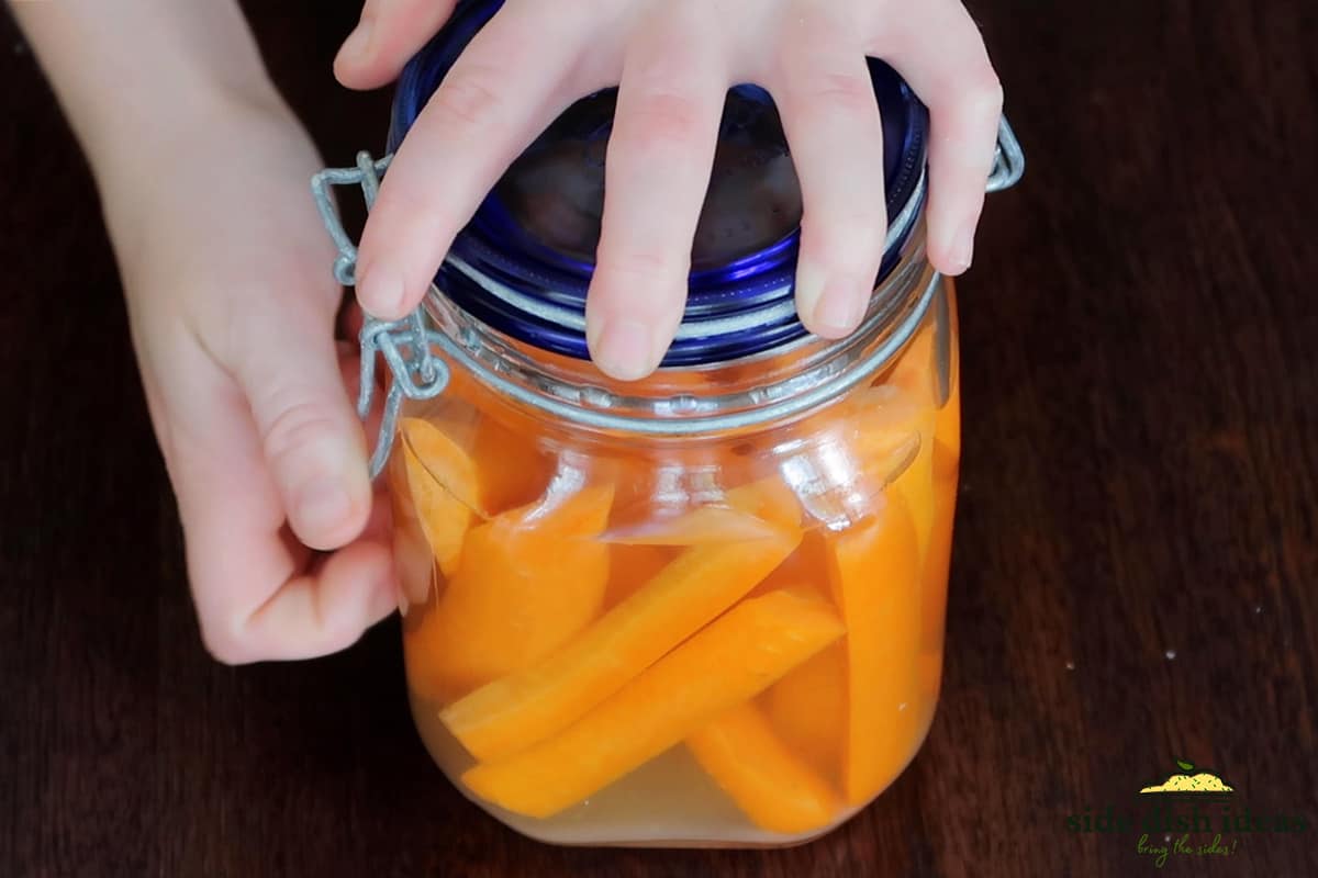 securing lid of pickled carrots