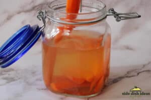 removing a pickled carrot from glass jar