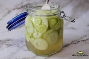 fork inside of jar of pickled cucumbers