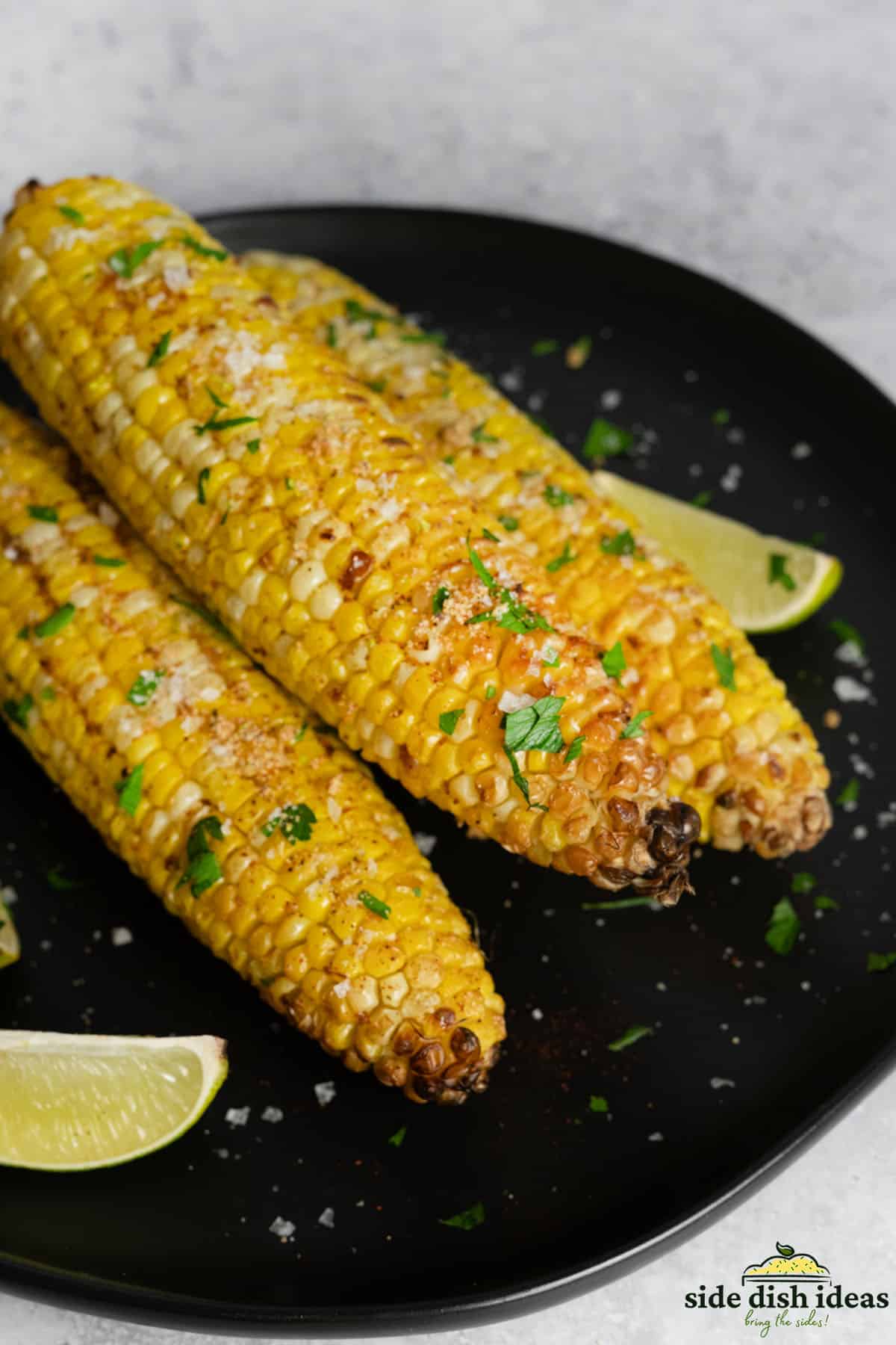 air fried corn on the cob on a black plate