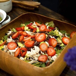 strawberry salad in a wooden square bowl with nuts and chicken